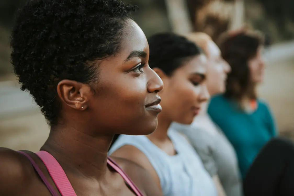 A woman looking into the distance, with friends beside her