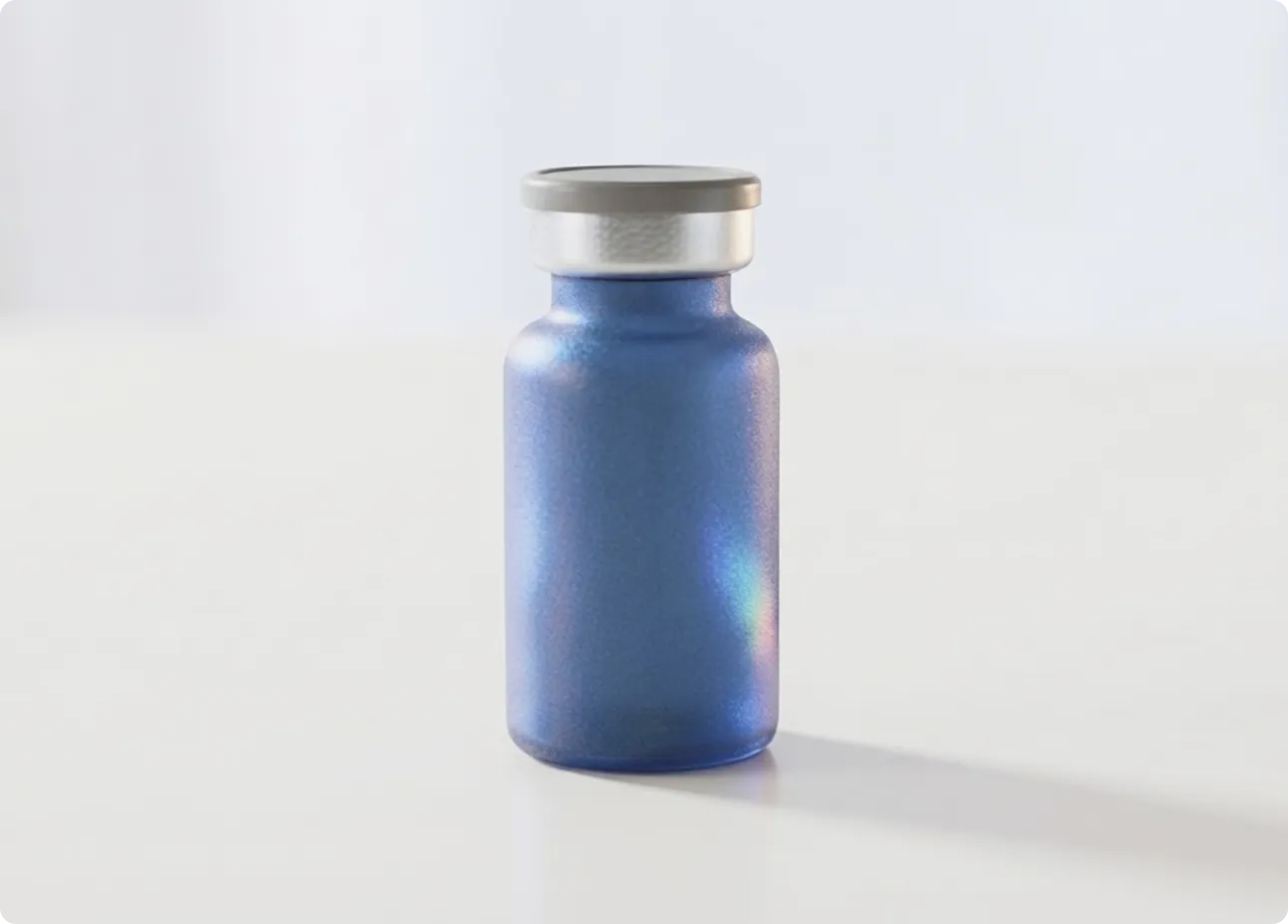 A vial of compounded tirzepatide on a pale surface